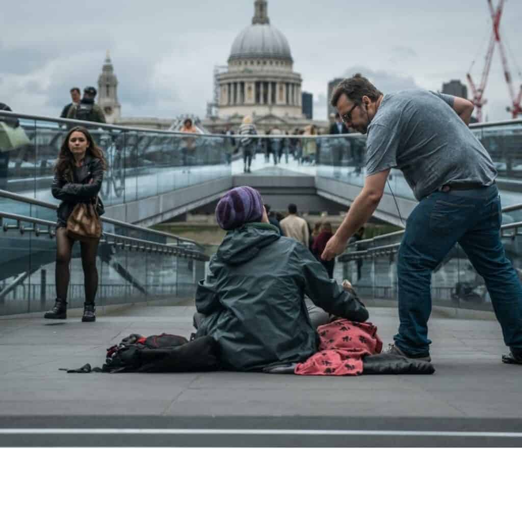 Man offering to help a homeless person in London
